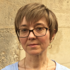 A photo of a white woman with blond hair and glasses