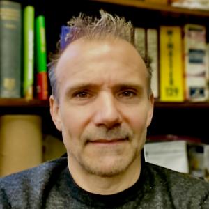 A photo of Jimmy Andrello. He is wearing a grey shirt.