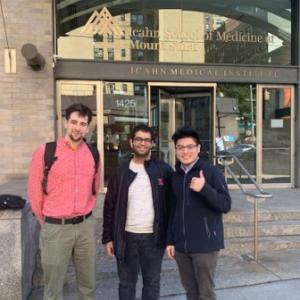 Three students stand outside of the Icahn School of Medicine