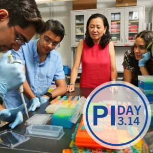 Three students are working in a lab with a professor