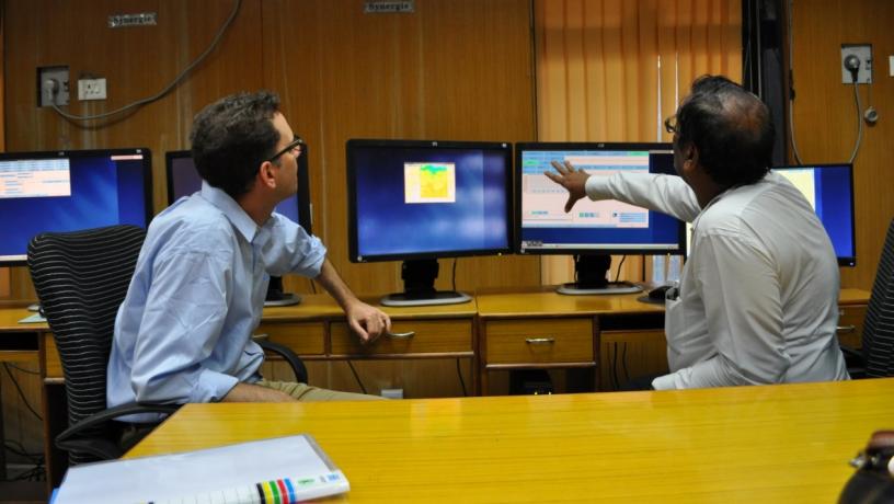Two men looking at computer monitors
