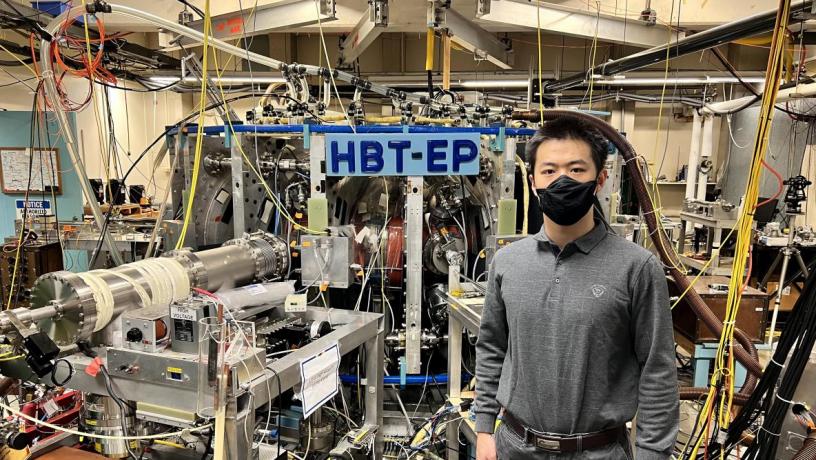 Yumou Wei stands in front of the HBT-EP experiment