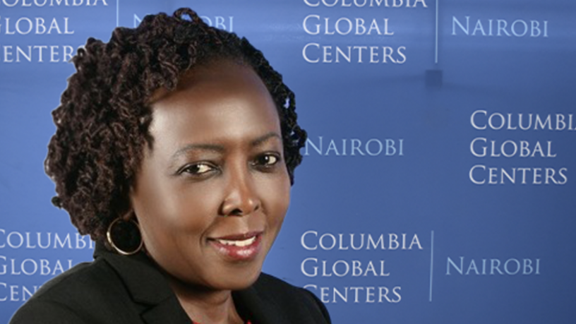 A photo of a woman standing in front of a blue background with the Columbia Global Centers logo
