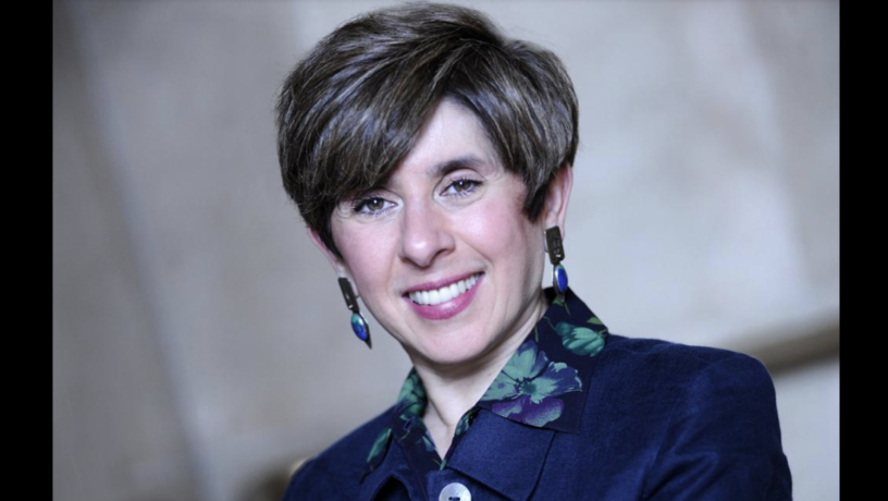 Photo of Professor Katayun Barmak. She is smiling and wearing a blue jacket and printed blue and green shirt.