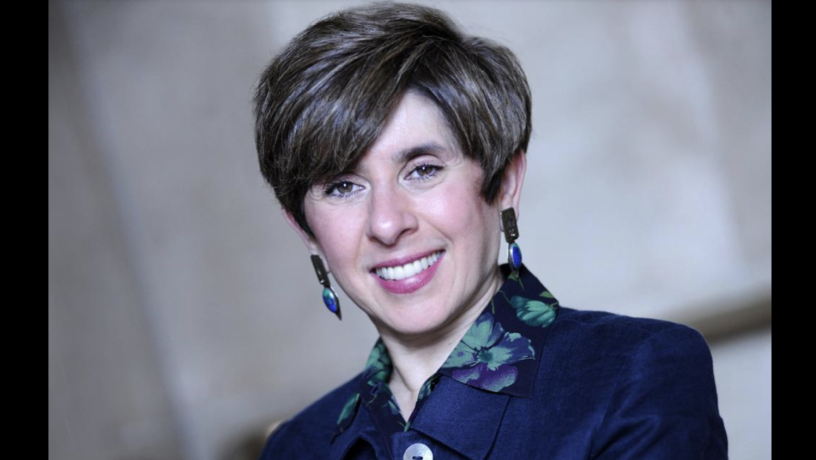 Photo of Professor Katayun Barmak. She is smiling and wearing a blue jacket and printed blue and green shirt. 