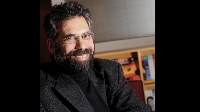 Photo of Professor Marc Spiegelman. He is smiling, wearing glasses, and wearing a black top and dark gray jacket.