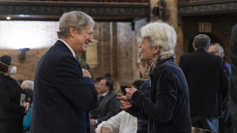 Two people standing and talking