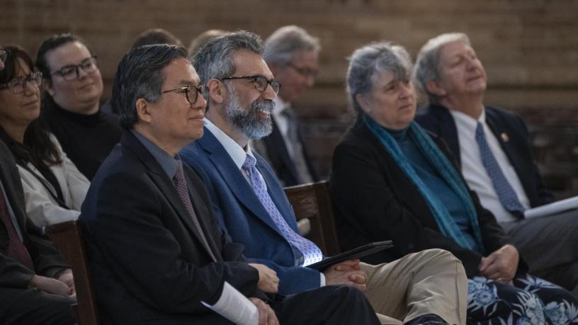 People sitting in a chapel and smiling