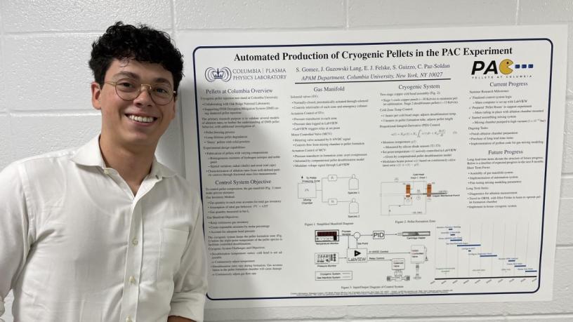 A student stands in front of their research project