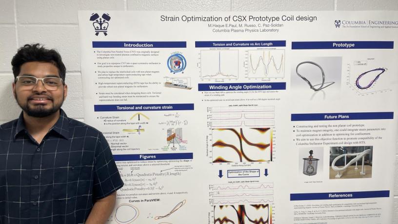 A student stands in front of their research poster