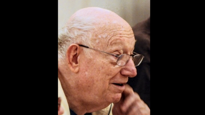 A photo of an elderly white man who is wearing glasses and looking away from the camers
