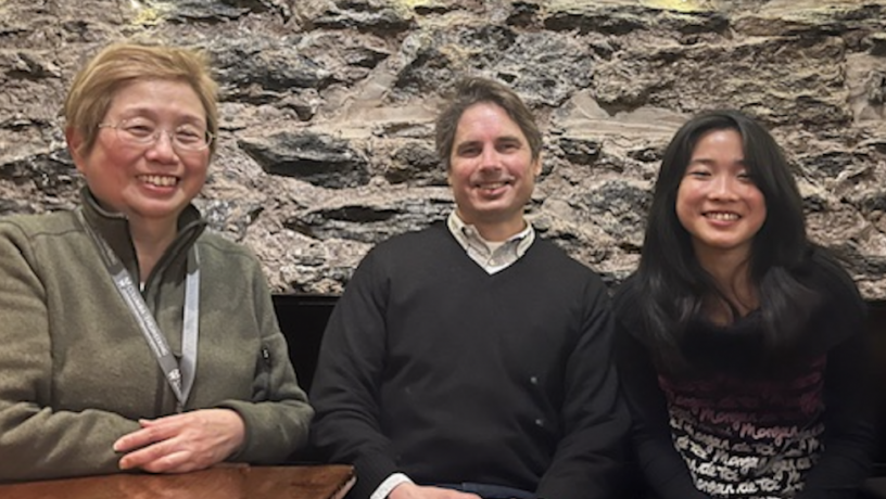 An older woman, a middle-aged man, and young woman sitting at a table