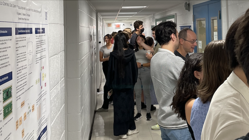 Students stand in front of a research poster