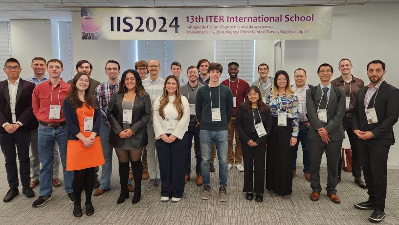 A group of students stand inside an office