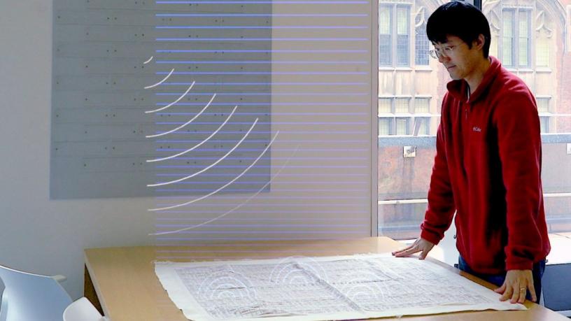 an image of a person standing by a table
