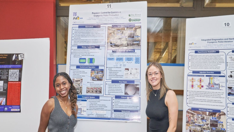 two women in front of a poster