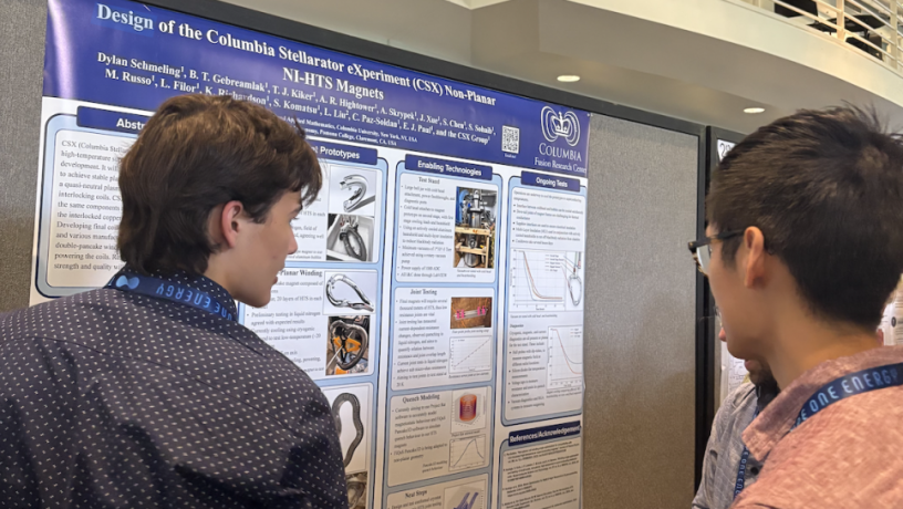 Two students looking at a poster