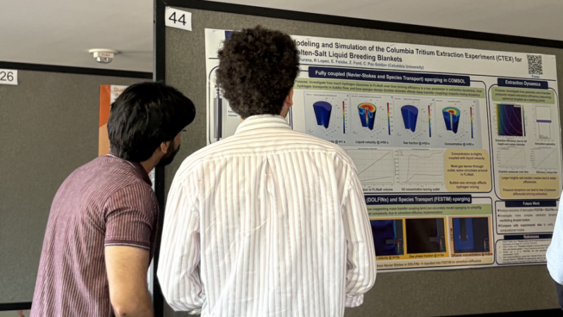 Two students looking at a poster