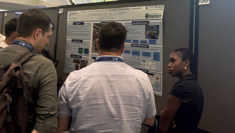 three students looking at a poster