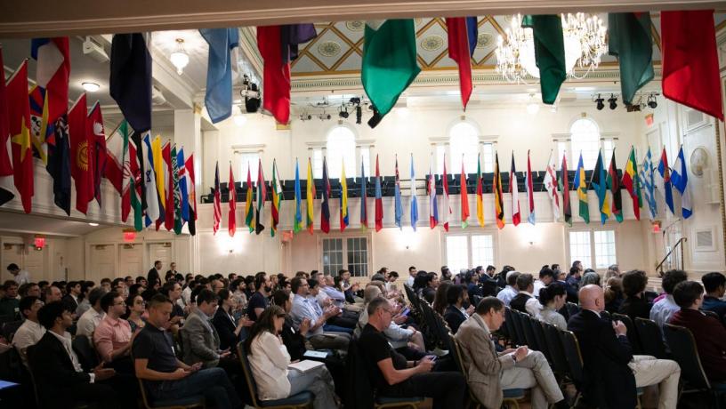 a large room with people decorated with flags from different countries