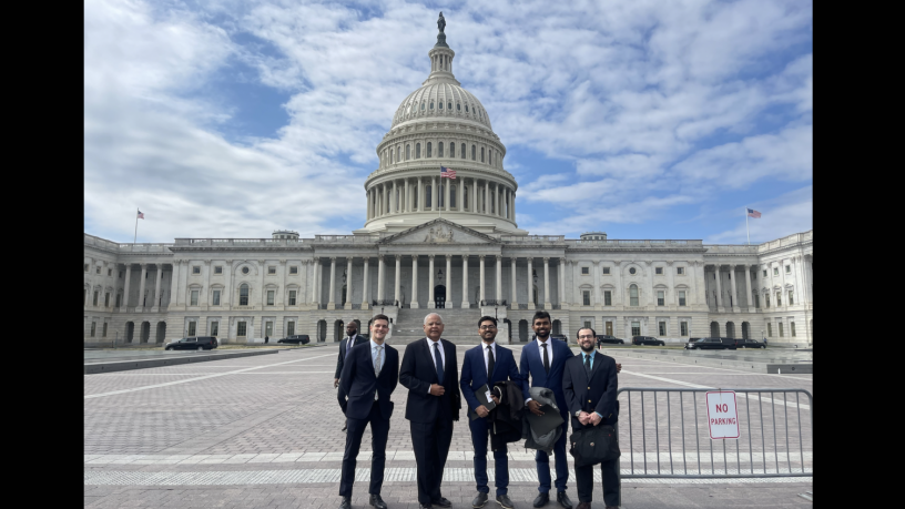 a group of people standing outside the US Capitol Building