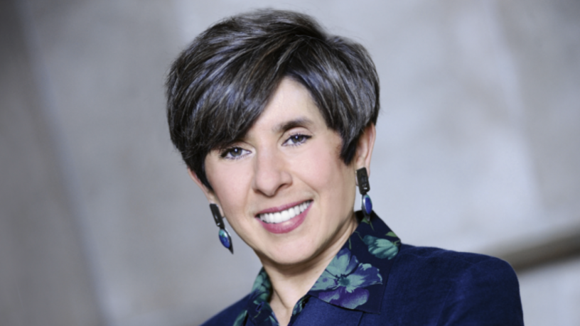 a photo of a woman in a blue jacket
