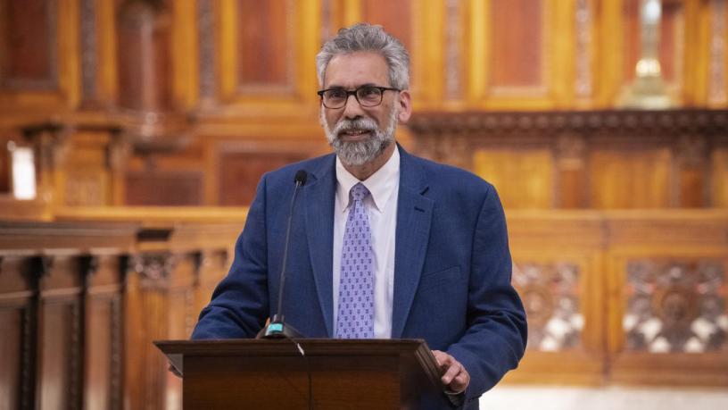 a photo of a man at a podium in a chapel