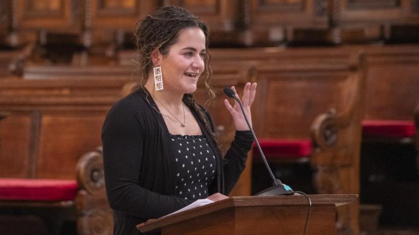 a photo of a woman at a podium in a chapel