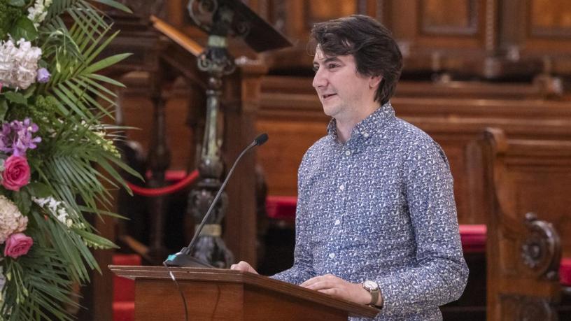 a photo of a man at a podium in a chapel