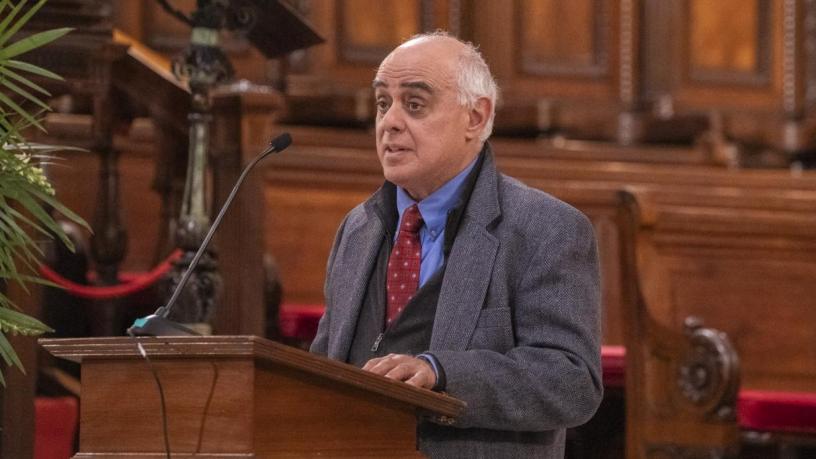 a photo of a man at a podium in a chapel