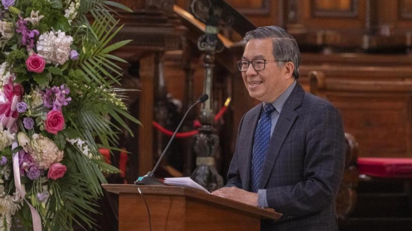 a photo of a man at a podium in a chapel