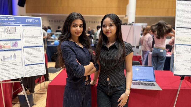 students standing in front of a poster