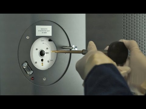 A scientist adjusting a transmission microscopy instrument