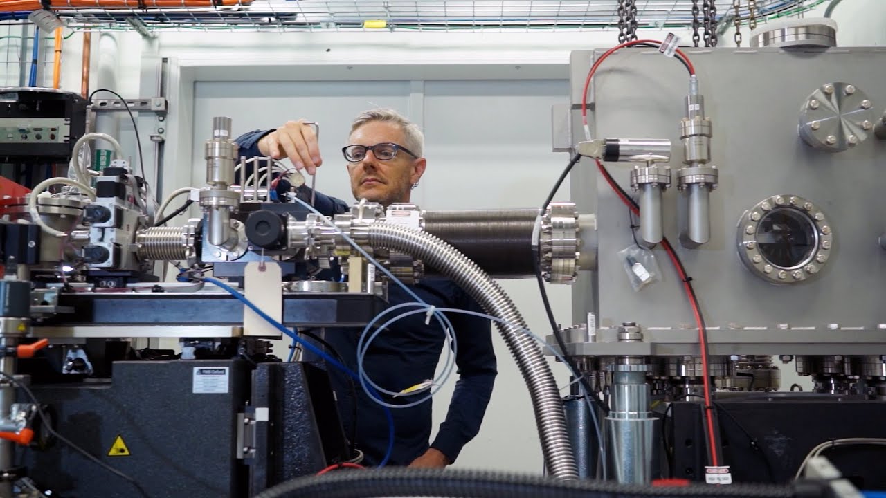 A researcher working with complex lab equipment