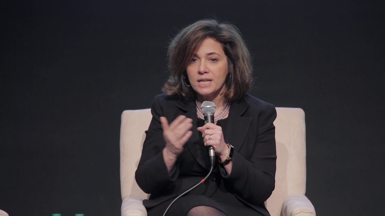 A speaker presenting on stage