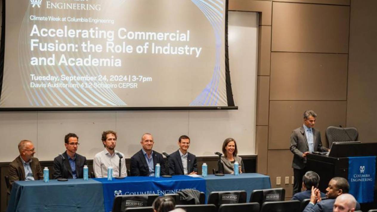 Panel discussion at Columbia Engineering’s Climate Week event, “Accelerating Commercial Fusion: the Role of Industry and Academia.” Six panelists sit at a table while a speaker stands at a podium; the event title and September 24, 2024 date are projected on a screen behind them.