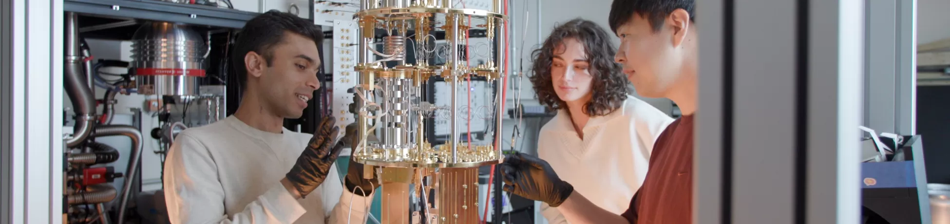 engineering students inspecting an experimental device
